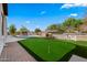 Pool, putting green, and pergola in backyard at 21086 E Mewes Rd, Queen Creek, AZ 85142