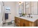 Modern bathroom with double vanity, wood cabinets, and a walk-in shower at 21086 E Mewes Rd, Queen Creek, AZ 85142