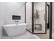 Bathroom with freestanding tub and glass enclosure at 21086 E Mewes Rd, Queen Creek, AZ 85142