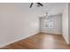 Bright bedroom with light walls, wood floors, and ceiling fan at 21086 E Mewes Rd, Queen Creek, AZ 85142