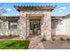 Inviting house entrance with stone accents and a glass door at 21086 E Mewes Rd, Queen Creek, AZ 85142