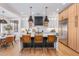 Modern kitchen with white cabinets, a large island, and wood flooring at 21086 E Mewes Rd, Queen Creek, AZ 85142