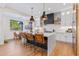 Modern kitchen with white cabinets, large island, and stylish light fixtures at 21086 E Mewes Rd, Queen Creek, AZ 85142