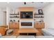 Modern living room boasts a fireplace, built-in shelving, and comfortable seating at 21086 E Mewes Rd, Queen Creek, AZ 85142