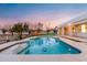 Relaxing kidney-shaped pool with dolphin tile accents at 21086 E Mewes Rd, Queen Creek, AZ 85142