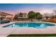 Inviting kidney-shaped pool with a relaxing patio and pergola at 21086 E Mewes Rd, Queen Creek, AZ 85142