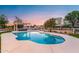 Inviting kidney-shaped pool with pergola and patio; serene sunset view at 21086 E Mewes Rd, Queen Creek, AZ 85142