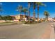 Marbella community entrance featuring lush palms and well-maintained landscaping under a clear blue sky at 2159 S Luther --, Mesa, AZ 85209