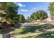 Scenic view of a community park with grassy areas, mature trees, and walking paths, perfect for outdoor activities at 2159 S Luther --, Mesa, AZ 85209