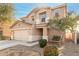 Tan two-story home featuring a two-car garage, manicured landscaping, and a front entryway at 2159 S Luther --, Mesa, AZ 85209