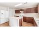 Bright kitchen with an island, white appliances, wood floors and dark-stained cabinets at 2159 S Luther --, Mesa, AZ 85209