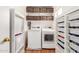 Laundry room with white washer and dryer and shelving and bins for organized storage at 2159 S Luther --, Mesa, AZ 85209