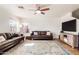 Bright living room featuring wood floors, ceiling fan, and two leather sofas with throw pillows at 2159 S Luther --, Mesa, AZ 85209