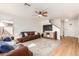 Open-concept living room featuring wood floors, ceiling fan, and two leather sofas with throw pillows at 2159 S Luther --, Mesa, AZ 85209