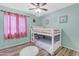 Bedroom with a bunk bed, wood floors, and pink accents at 2218 E Gillcrest Rd, Gilbert, AZ 85298