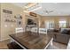 Casual dining area with farmhouse table, adjacent to living room at 2218 E Gillcrest Rd, Gilbert, AZ 85298