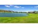 Lake view with water fountains and lush green grass at 2218 E Gillcrest Rd, Gilbert, AZ 85298