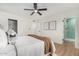 Bedroom with ceiling fan, neutral decor, and ensuite bath at 252 S Cholla St, Gilbert, AZ 85233