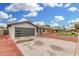 Newly remodeled home with gray garage door and red rock landscaping at 252 S Cholla St, Gilbert, AZ 85233