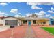 Updated single-level home with gray garage door, blue front door, and landscaped yard at 252 S Cholla St, Gilbert, AZ 85233