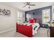 Youth bedroom with a red bed and ceiling fan at 25509 N 140Th Dr, Surprise, AZ 85387