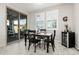 Casual dining area with a dark wood table, four chairs, and sliding glass doors to the patio at 25509 N 140Th Dr, Surprise, AZ 85387