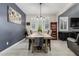 Bright dining room features a large wooden table with seating for four and a chandelier at 25509 N 140Th Dr, Surprise, AZ 85387