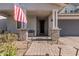 Covered front porch with brick columns and American flag at 25509 N 140Th Dr, Surprise, AZ 85387