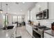 Modern kitchen with stainless steel appliances and gray countertops, island and breakfast bar at 25509 N 140Th Dr, Surprise, AZ 85387