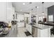 Modern kitchen with white cabinets, gray countertops, island, and stainless steel appliances at 25509 N 140Th Dr, Surprise, AZ 85387