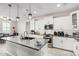 Modern kitchen with white cabinets, gray countertops and island with breakfast bar at 25509 N 140Th Dr, Surprise, AZ 85387