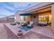 Evening view of backyard patio with seating area and string lights at 26063 N 83Rd Dr, Peoria, AZ 85383