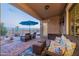 Relaxing backyard patio with seating area, umbrella, and brick pavers at 26063 N 83Rd Dr, Peoria, AZ 85383