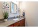 Bathroom with single vanity, granite countertop and wood cabinets at 26063 N 83Rd Dr, Peoria, AZ 85383