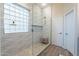 Spa-like shower with glass enclosure, pebble flooring and a built-in bench at 26063 N 83Rd Dr, Peoria, AZ 85383