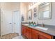 Double vanity bathroom with granite countertops and wood cabinets at 26063 N 83Rd Dr, Peoria, AZ 85383