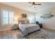 Bright bedroom with ceiling fan, plantation shutters and ensuite bathroom at 26063 N 83Rd Dr, Peoria, AZ 85383