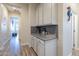 Light and bright hallway with built-in cabinetry and wood-look flooring at 26063 N 83Rd Dr, Peoria, AZ 85383