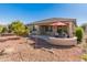 Landscaped backyard with patio and citrus trees at 26458 W Yukon Dr, Buckeye, AZ 85396