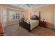 Spacious bedroom with a wooden bed frame and plenty of natural light from a bay window at 26458 W Yukon Dr, Buckeye, AZ 85396