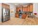 Kitchen boasts granite countertops, stainless steel appliances, and wood cabinets at 26458 W Yukon Dr, Buckeye, AZ 85396