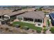 Aerial view showcasing backyard with patio, grass, and surrounding homes at 30401 N 115Th Dr, Peoria, AZ 85383