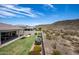 Backyard with grassy lawn, patio, and desert mountain views at 30401 N 115Th Dr, Peoria, AZ 85383