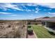 Backyard with a grassy lawn, desert landscape, and a fence at 30401 N 115Th Dr, Peoria, AZ 85383