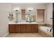 Elegant bathroom with double vanity, soaking tub, and separate shower at 30401 N 115Th Dr, Peoria, AZ 85383