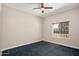 Simple bedroom with ceiling fan, window, and neutral carpet at 30401 N 115Th Dr, Peoria, AZ 85383