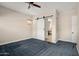 Bright bedroom featuring a barn door and plush carpeting at 30401 N 115Th Dr, Peoria, AZ 85383