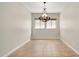 Bright dining room with tile floors and chandelier at 30401 N 115Th Dr, Peoria, AZ 85383