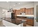 Modern kitchen with granite countertops and stainless steel appliances at 30401 N 115Th Dr, Peoria, AZ 85383