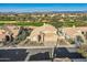 Aerial view of a single-Gathering home, golf course and desert landscape in distance at 30626 N 45Th Pl, Cave Creek, AZ 85331